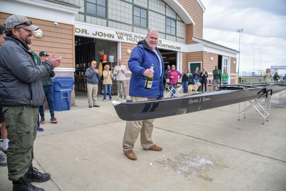 Former Mainland Crew Coach Steven J. Brown, from Atlantic City, christens a new crew boat dedicated in his honor during the First Annual Back Bay Challenge held at the Dr. John W. Holland Boathouse in Ventnor. Dave Griffin / for the Press
