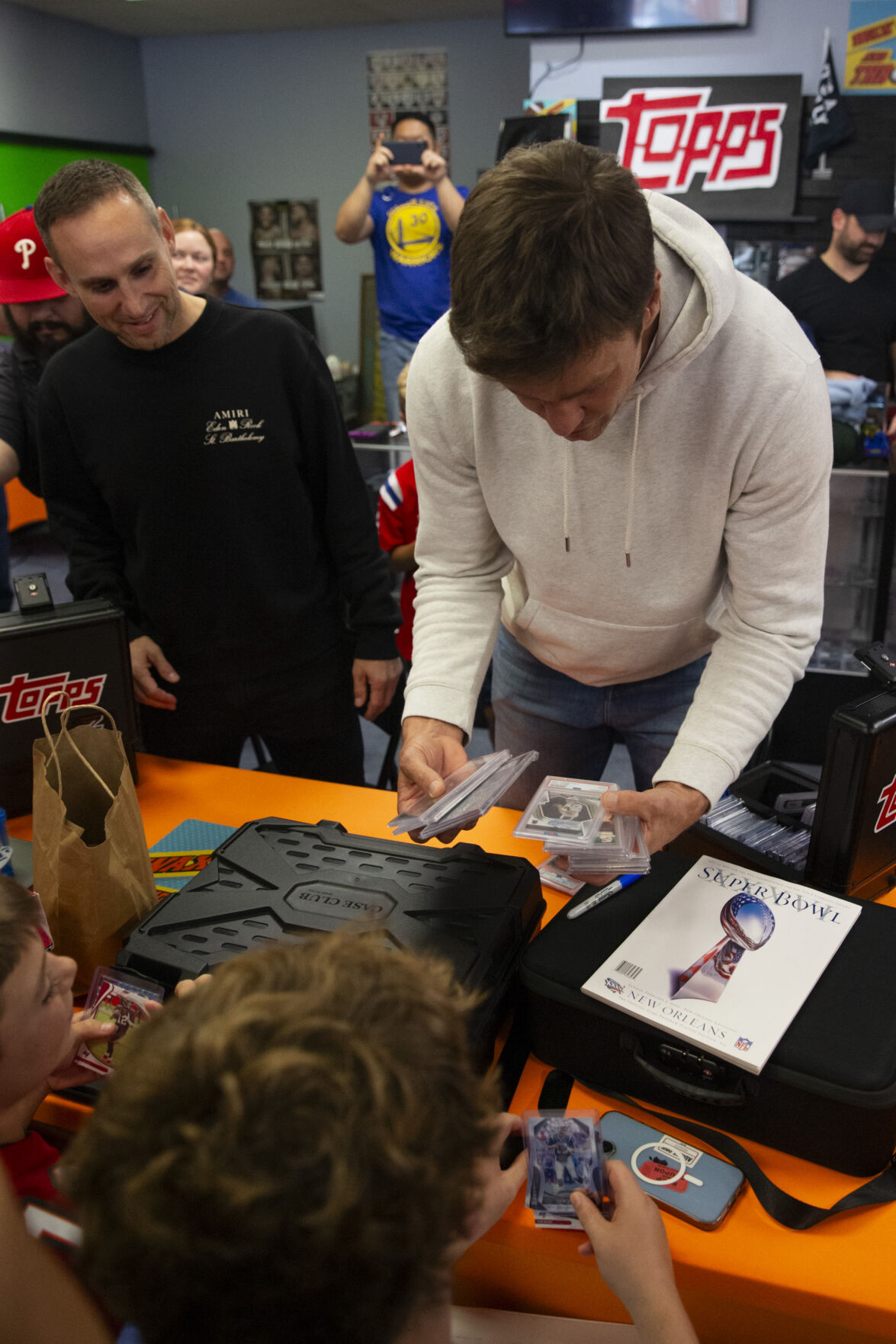 Tom Brady Makes Surprise Visit to Trading Card Store with Kevin Hart,  Travis Scott