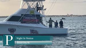 Decorated boats lit up during the Night in Venice annual boat parade in Ocean City, New Jersey