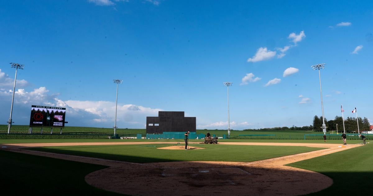 The grounds crew works on the field as the Clinton and Western Dubuque varsity baseball teams warm up June 17, 2026 at the Field of Dreams Ballpark in Dyersville, Iowa.