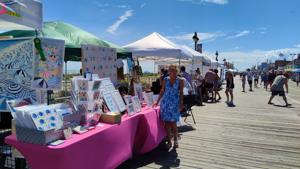 Artists displaying artwork along the Ocean City Boardwalk during a weekend art show