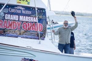 Actor Randy Quaid waving to crowd at Night In Venice boat parade in Ocean City