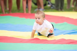 Infants and toddlers participate in the Baby Waddle crawling competition at Wildwood Convention Center.