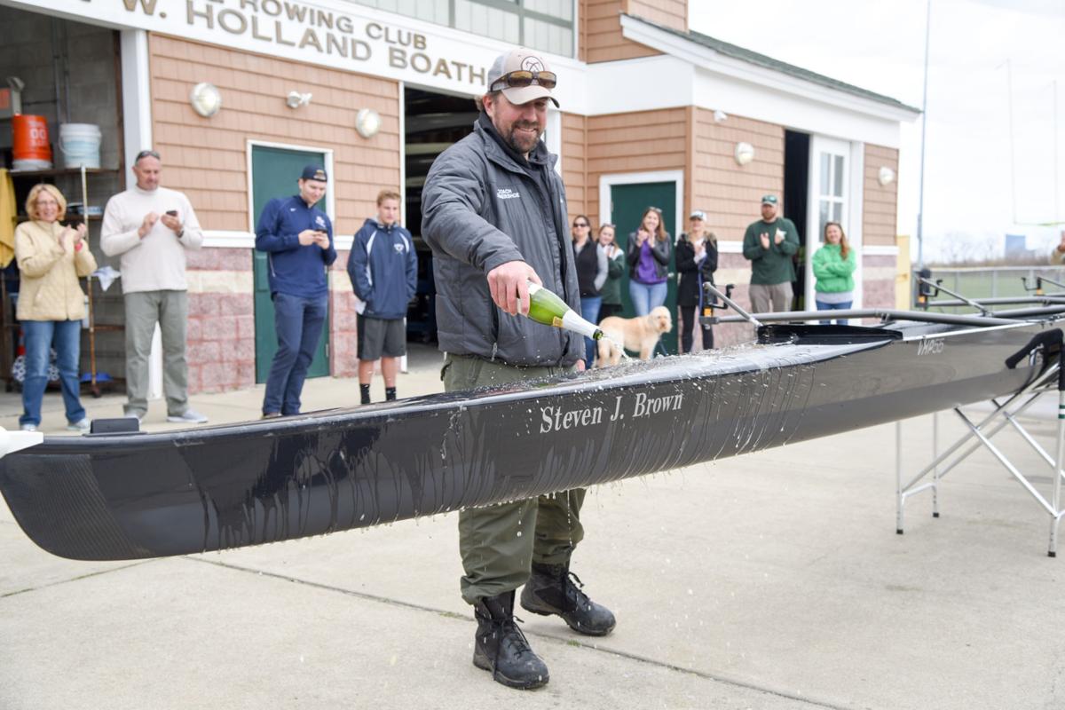 Mainland Crew Eric Somershoe, from Ventnor, christens a new crew boat dedicated to former Mainland Crew Coach Steven J. Brown during the First Annual Back Bay Challenge held at the Dr. John W. Holland Boathouse in Ventnor. Dave Griffin / for the Press