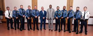 Atlantic City Public Safety Director Sean Riggin and Mayor Marty Small Sr. stand with newly promoted Police Department members at the All Wars Memorial Building