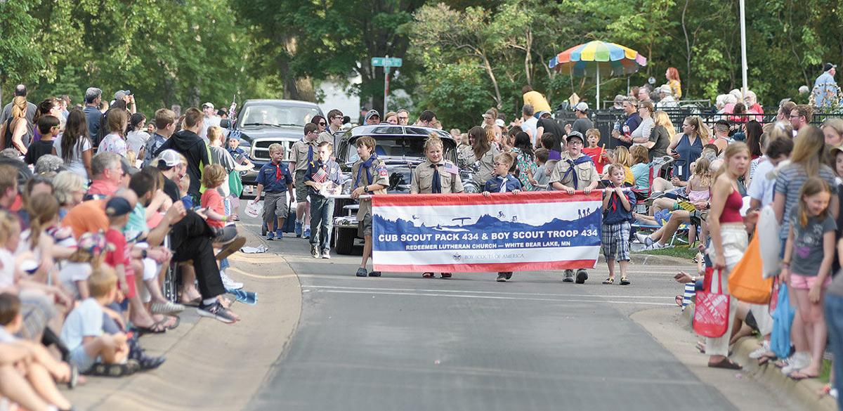 Many flags flying at Manitou Days parade White Bear