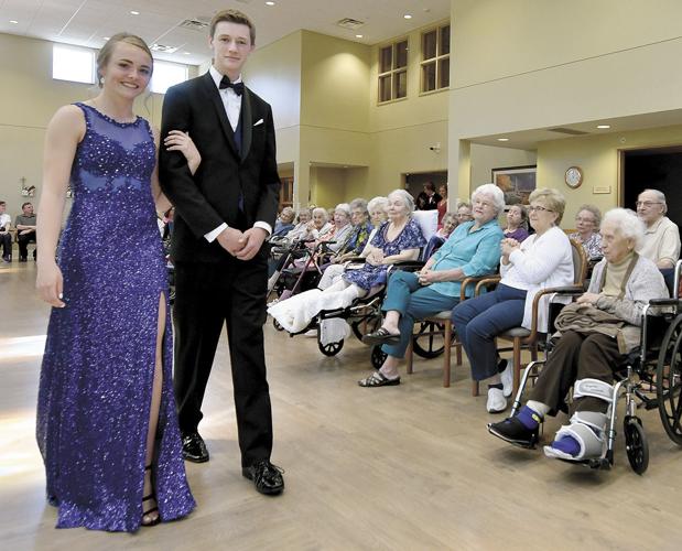 Students take a prom march through Cerenity Senior Care Center