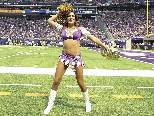 A Minnesota Vikings cheerleader performs during the first half of