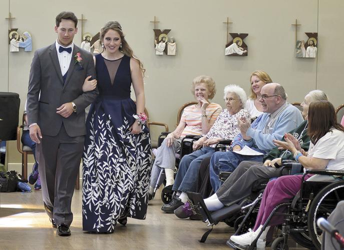 Students take a prom march through Cerenity Senior Care Center