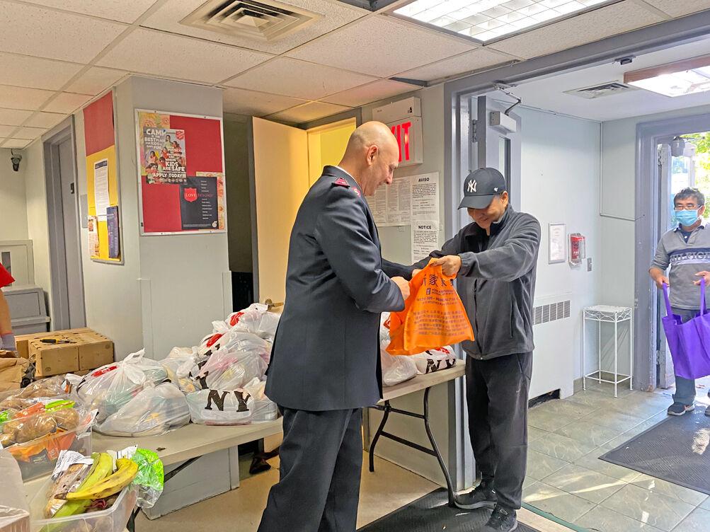 Salvation officer Lieutenant Esther Mosley of The Salvation Army Stapleton Corps and Community Center standing with a Salvation Army patron.