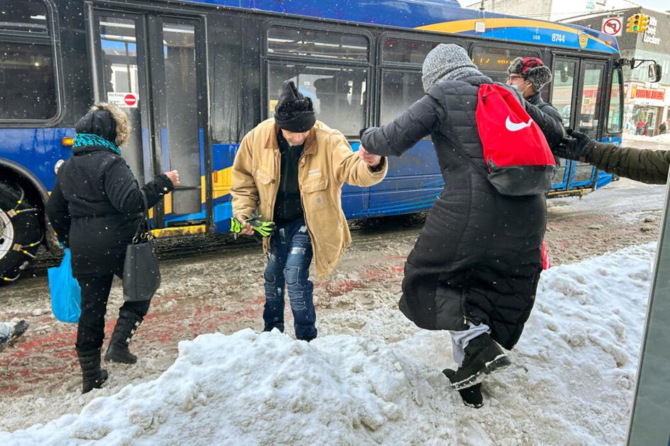 Climbing bus stop mountain: Snowfall makes a mess