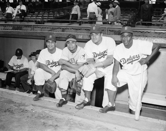 Jackie Robinson, signed by the Brooklyn Dodgers and assigned to the  Montreal Club, holds hands with his bride, the former Rachel Isum in Los  Angeles, Feb. 26, 1946. The couple disclosed in