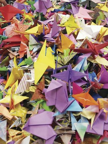 Red Origami Paper Cranes Flying Away From Hands Photo Photograph
