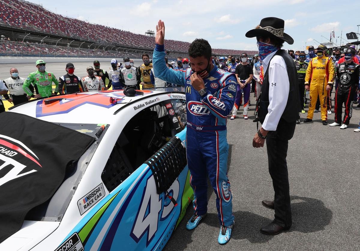 Bubba Wallace, driver of the #43 Victory Junction Chevrolet, and NASCAR Hall of Famer and team owner Richard Petty look on after NASCAR drivers pushed Wallace to the front of the grid as a sign of solidarity with the driver prior to the NASCAR Cup Series GEICO 500 at Talladega Superspeedway on June 22, 2020 in Talladega, Ala. A noose was found in the garage stall of NASCAR driver Bubba Wallace at Talladega Superspeedway a week after the organization banned the Confederate flag at its facilities.