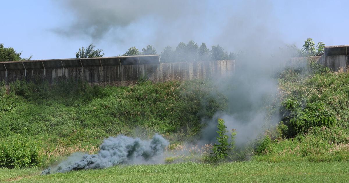 Scott County deputy demonstrates using a smoke bomb