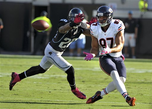 Chicago Bears cornerback Charles Tillman (33), outside linebacker Lance  Briggs (55) and middle linebacker Brian Urlacher (54) run to the sideline  after Briggs returned an interception for a touchdown during the second