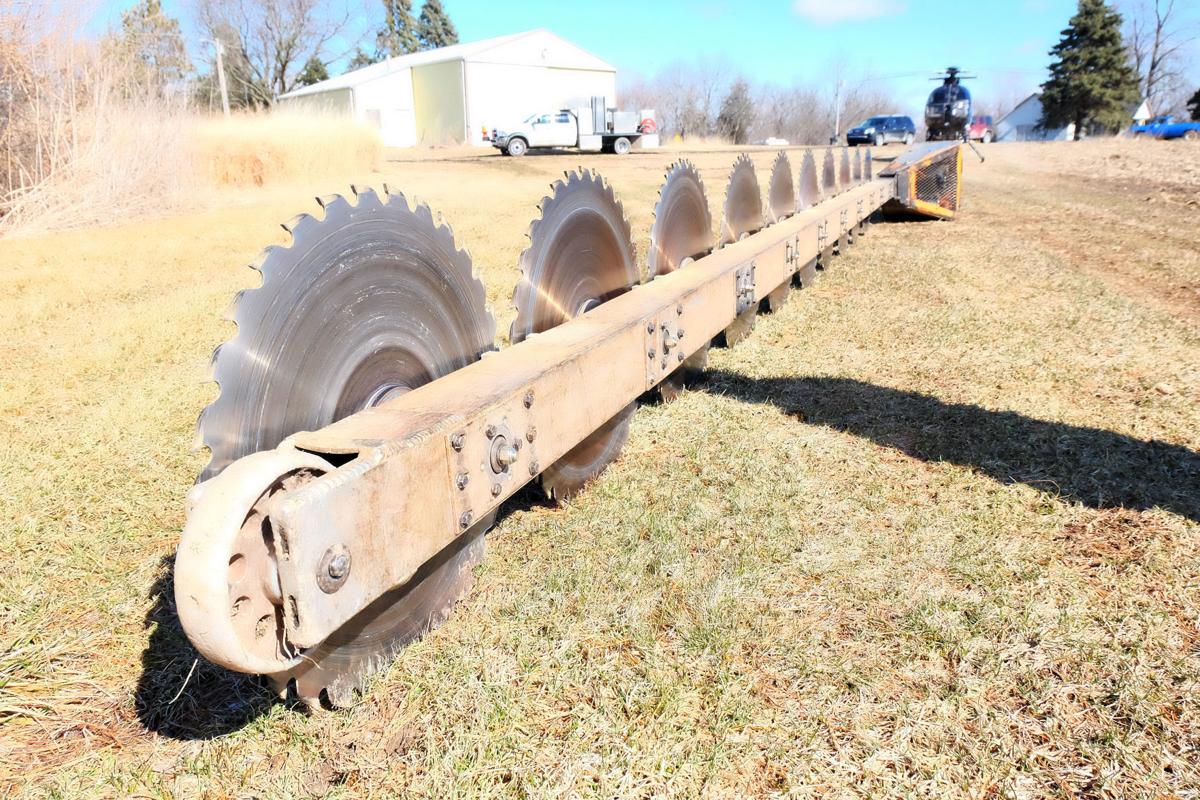 Helicopter uses massive saw to clear rail line Muscatine