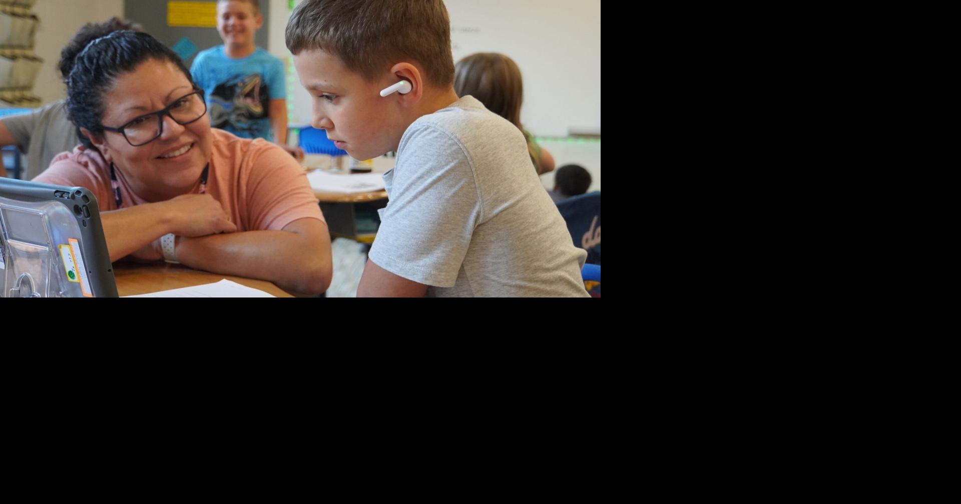 Jefferson Elemen uses translator earbuds to communicate w English-learning students