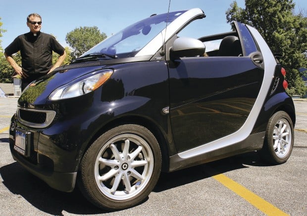 Priest Shrinks Carbon Footprint With Smart Car Local News The Rev Rich Adam Pastor Of Sacred Heart Cathedral In Davenport Says His New Smart Car Runs On A Three Cylinder Engine And Gets 45 Miles Per Gallon
