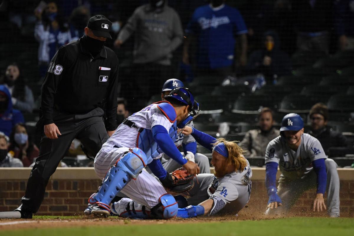 Justin Turner #10 of the Los Angeles Dodgers is tagged out in the 10th inning by Willson Contreras #40 of the Chicago Cubs at Wrigley Field on May 05, 2021 in Chicago, Illinois.