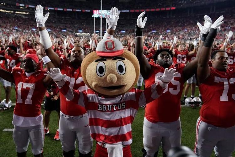 Ohio State mascot Brutus Buckeye sings "Carmen Ohio" with the team following the NCAA football game against the Minnesota Golden Gophers at Ohio Stadium in Columbus on Oct. 4, 2025. Ohio State won 42-3.