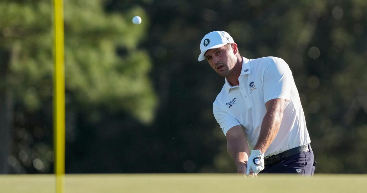 Bryson DeChambeau chips onto the 18th green during the second round of the Masters Tournament at Augusta National Golf Club.