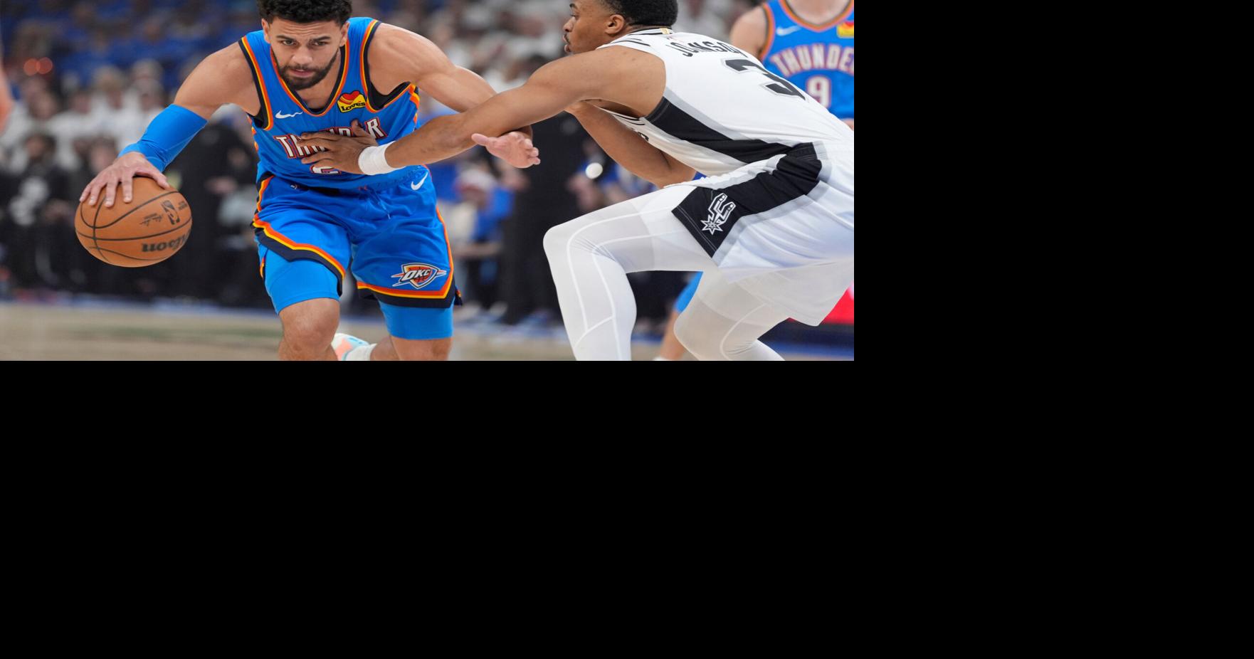 Oklahoma City Thunder guard Ajay Mitchell (25) dribbles beside San Antonio Spurs forward Keldon Johnson (3) during Game 2 of the Western Conference Finals between the Oklahoma City Thunder and the San Antonio Spurs at Paycom Center in Oklahoma City, Wednes