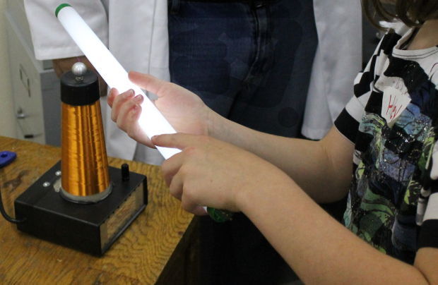 Student with Fluorescent Bulb