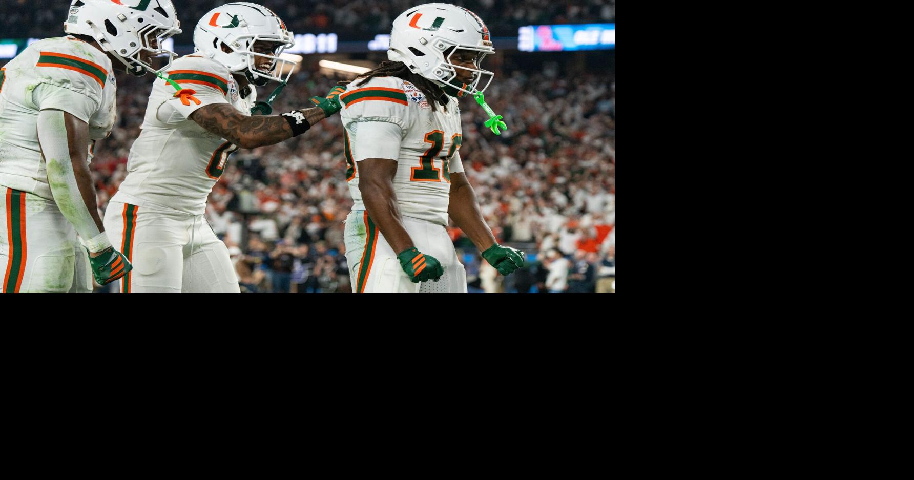 Miami Hurricanes wide receiver Keelan Marion (0) pats Malachi Toney (10) on the back after his touchdown during the CFP Fiesta Bowl at the State Farm Stadium, in Glendale, Ariz., on Thursday, Jan. 8, 2026.