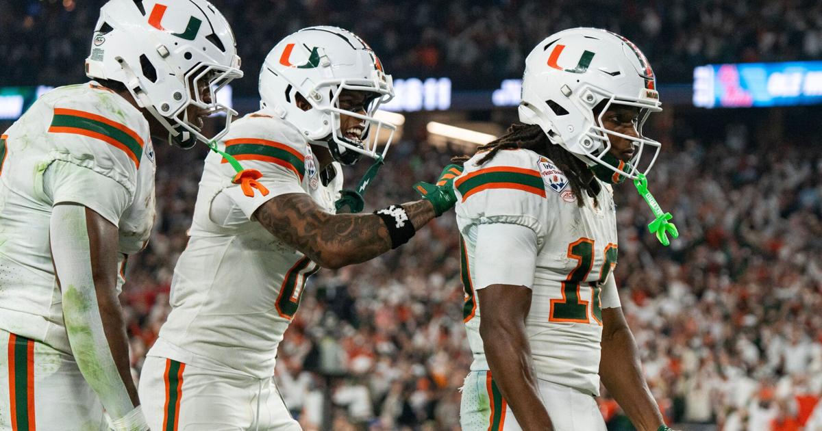 Miami Hurricanes wide receiver Keelan Marion (0) pats Malachi Toney (10) on the back after his touchdown during the CFP Fiesta Bowl at the State Farm Stadium, in Glendale, Ariz., on Thursday, Jan. 8, 2026.