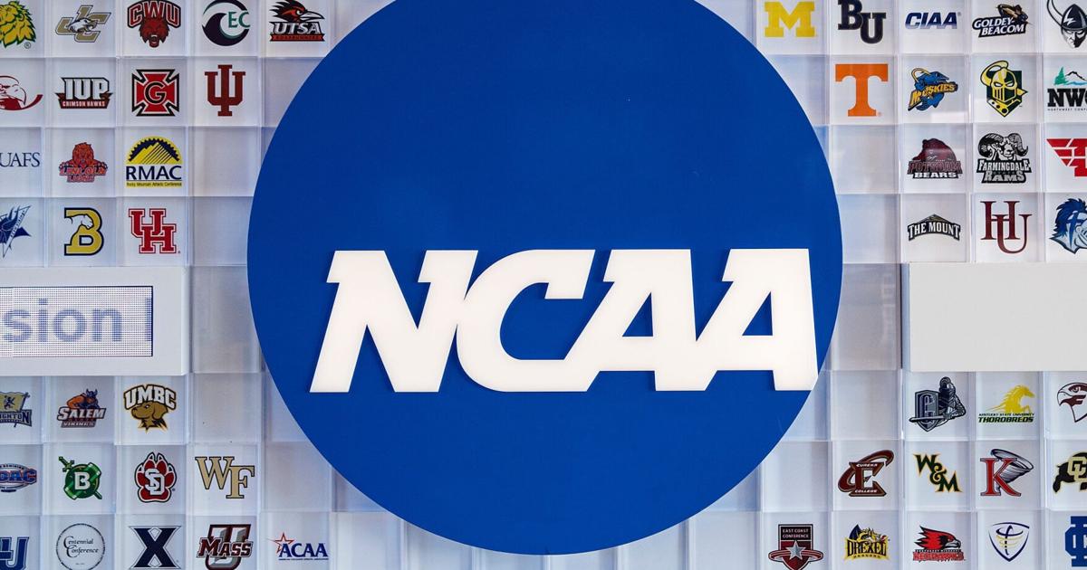 University logos cover a wall in the lobby of NCAA headquarters Thursday, Feb. 25, 2021, in Indianapolis.