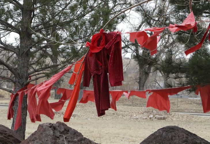 red dresses hanging from trees HEU Red Dress Event Toolkit