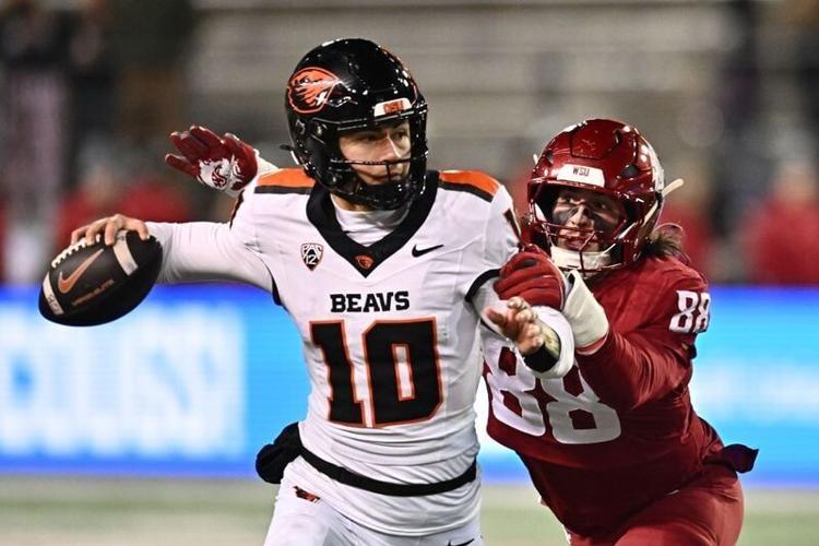 Oregon State Beavers quarterback Tristan Ti'A (10) gets his pass away before being sacked by Washington State Cougars defensive end Isaac Terrell (88) in the second half at Gesa Field at Martin Stadium. Washington State Cougars won 32-8.