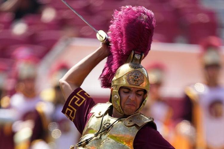 Sep 28, 2024; Los Angeles, California, USA; Southern California Trojans mascot Tommy Trojan leads the Spirit of Troy marching band onto the field during a game against the Wisconsin Badgers at United Airlines Field at Los Angeles Memorial Coliseum. Mand...