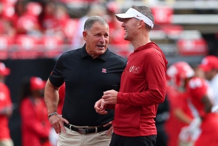 Sep 19, 2026; Piscataway, New Jersey, USA;  Rutgers Scarlet Knights head coach Greg Schiano, left, with teammates USC Trojans head coach Lincoln Riley before the game at SHI Stadium. Mandatory Credit: Vincent Carchietta-Imagn Images