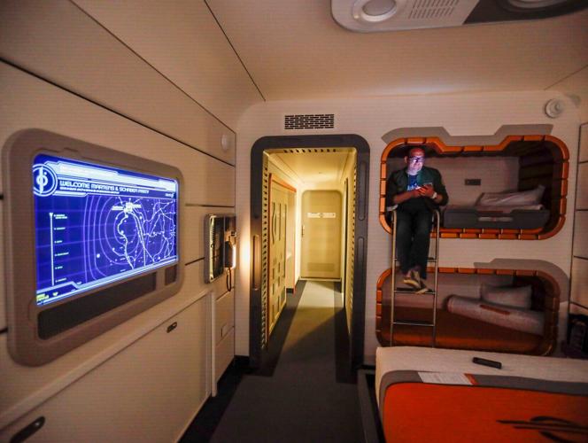 Todd Martens sits in one of the bunk beds inside a standard room aboard the Galactic Starcruiser.