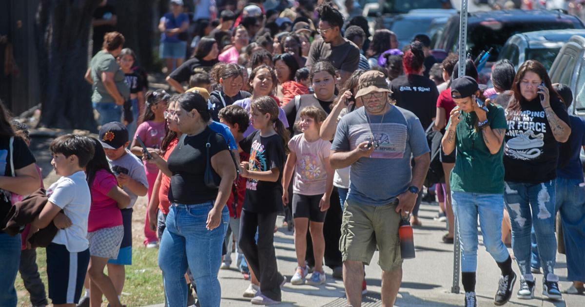Families line up along S. Van Buren Street at Weber Avenue to get a free backpack at the Stockton Unified School District’s 4th annual backpack giveaway at the Weber Institute of Applied Sciences and Technology in downtown Stockton on Jul. 28, 2026.