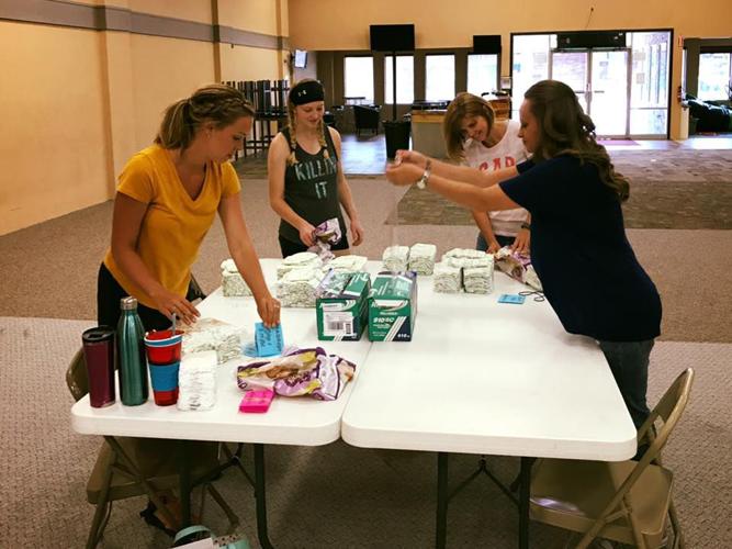 Volunteers repackage diapers