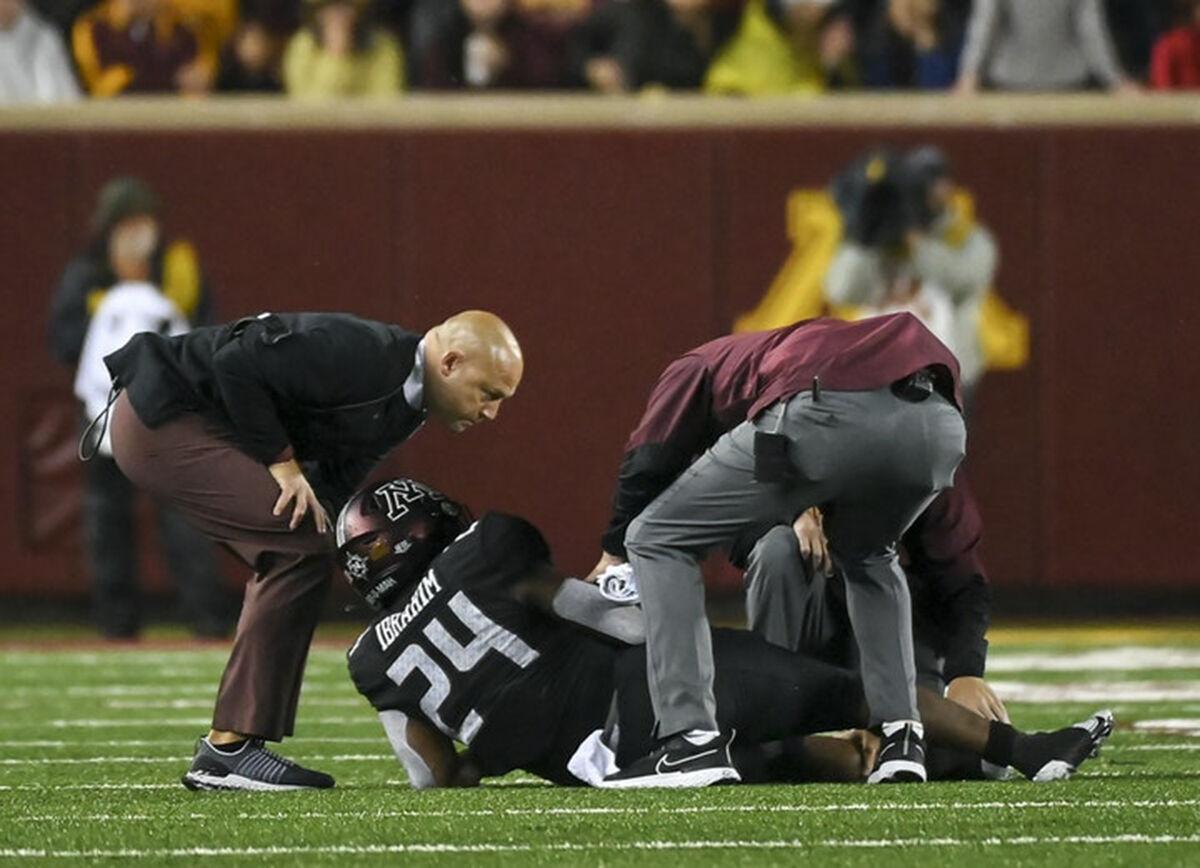 Minnesota Gophers head coach P.J. Fleck checks on Minnesota Golden Gophers running back Mohamed Ibrahim after he was injured in the second half against the Ohio State Buckeyes.