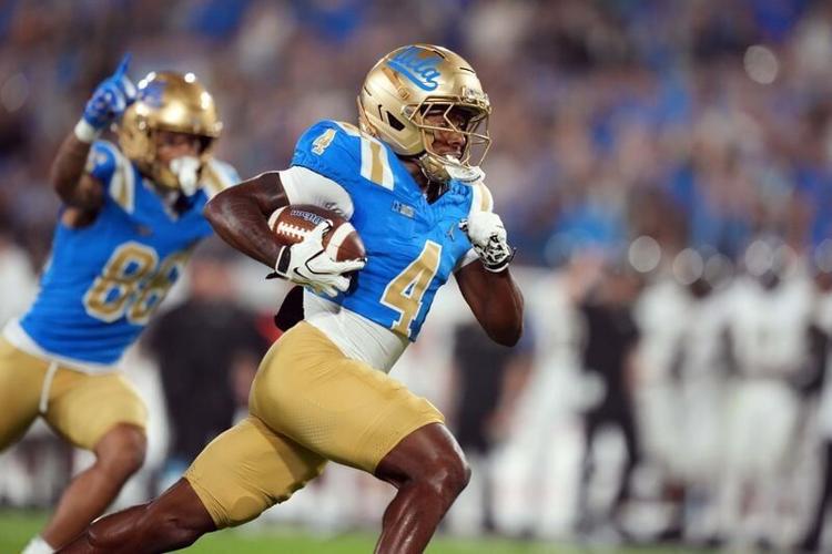 Sep 19, 2026; Pasadena, California, USA; UCLA Bruins wide receiver Semaj Morgan (4) scores on a 27-yard touchdown pass against the Purdue Boilermakers in the first half at the Rose Bowl. Mandatory Credit: Kirby Lee-Imagn Images