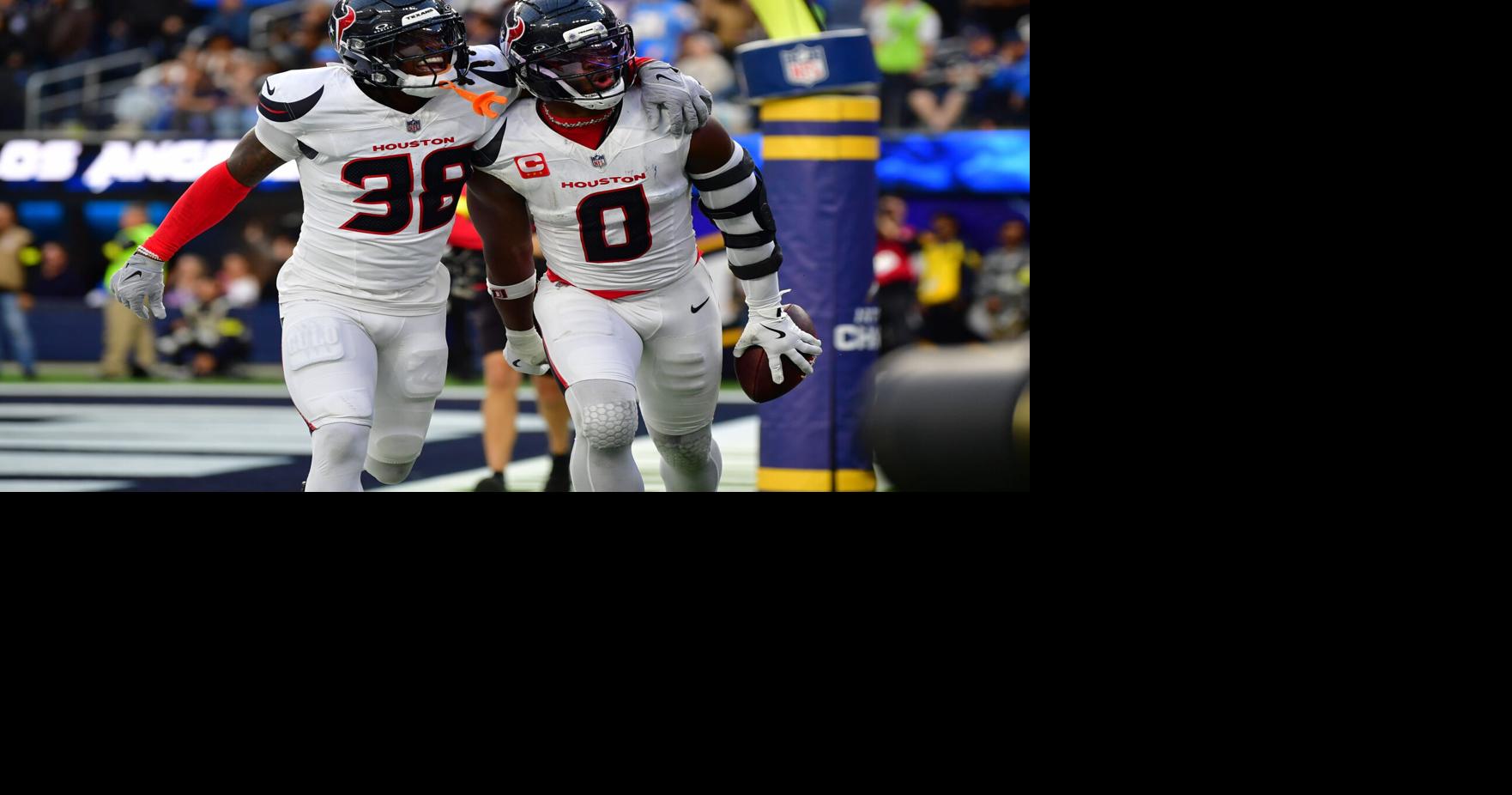 Dec 27, 2025; Inglewood, California, USA; Houston Texans linebacker Azeez al-Shaair (0) reacts with safety K'Von Wallace (38) after making an interception against the Los Angeles Chargers during the first half at SoFi Stadium. Mandatory Credit: Gary A. Vas