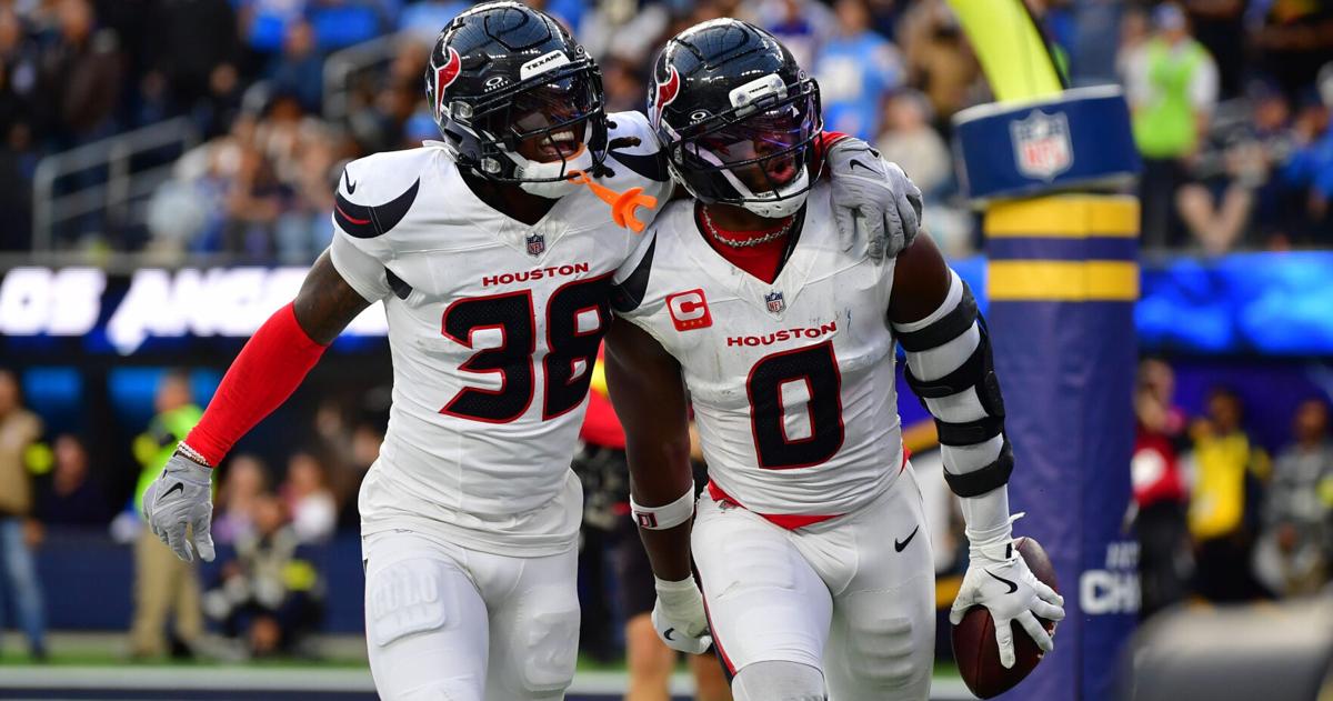 Dec 27, 2025; Inglewood, California, USA; Houston Texans linebacker Azeez al-Shaair (0) reacts with safety K'Von Wallace (38) after making an interception against the Los Angeles Chargers during the first half at SoFi Stadium. Mandatory Credit: Gary A. Vas