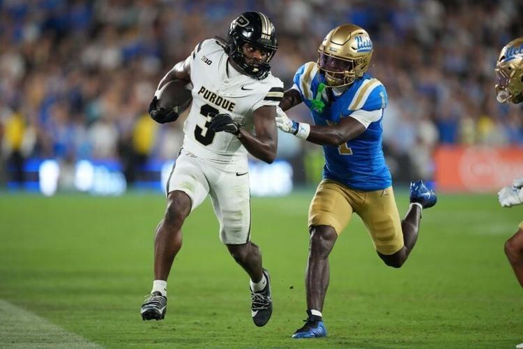 Sep 19, 2026; Pasadena, California, USA;Purdue Boilermakers wide receiver Xavier Townsend (3) carries the ball against UCLA Bruins defensive back Scooter Jackson (1)  in the first half at the Rose Bowl. Mandatory Credit: Kirby Lee-Imagn Images
