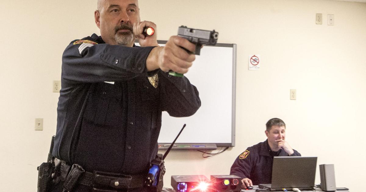 Officer Using Force Police use video training to practice use-of-force scenarios