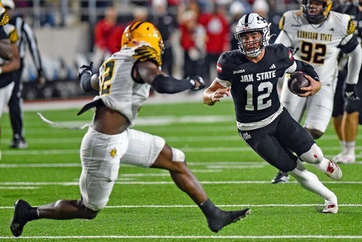 Jax State's Caden Creel tries to evade the tackle of Kennesaw State's Kody Jones during college school football action at AmFirst Stadium in Jacksonville, Alabama November 15, 2025. (Dave Hyatt / Hyatt Media LLC)