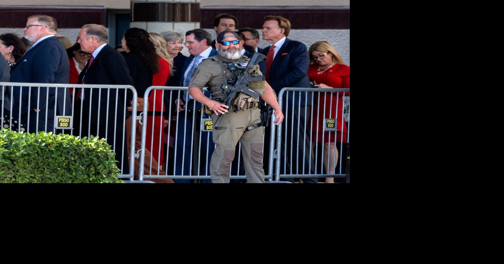A PBSO SWAT team member stands guard as guests arrive to go through security before President Donald Trump speaks to the Forum