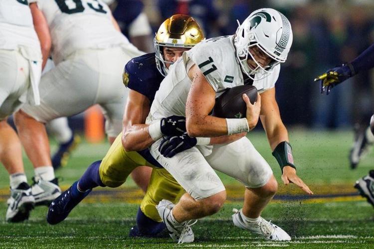 Notre Dame safety Luke Talich, left, sacks Michigan State quarterback Alessio Milivojevic (11) during a NCAA football game at Notre Dame Stadium on Saturday, Sept. 19, 2026, in South Bend.