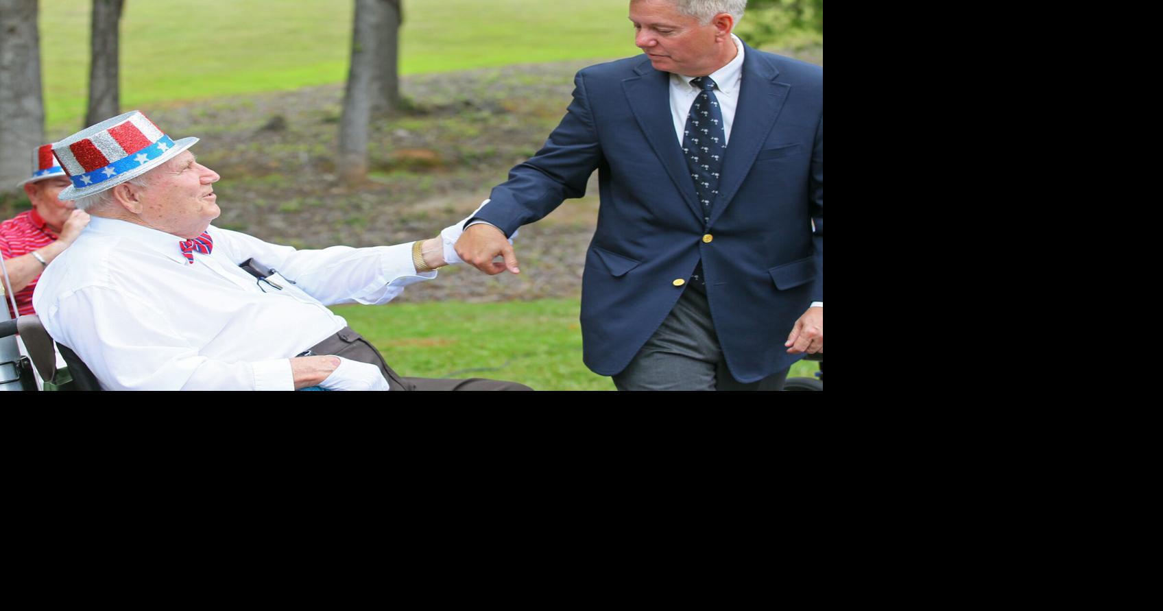 John Brown, director of music at Richard M. Campbell Veterans Nursing Home, greets U.S. Sen. Lindsey Graham after a Memorial Day