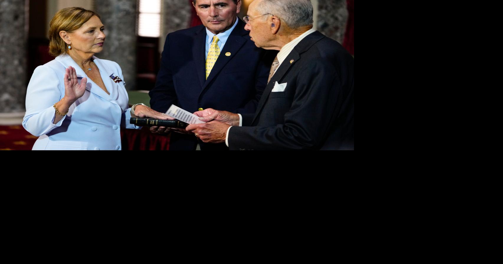 Darline Graham Nordone, left, standing with her husband Larry Nordone, takes part in a ceremonial swearing-in as a U.S. Senator