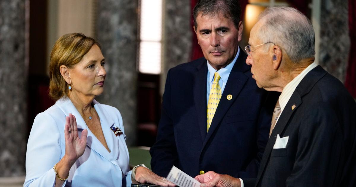 Darline Graham Nordone, left, standing with her husband Larry Nordone, takes part in a ceremonial swearing-in as a U.S. Senator